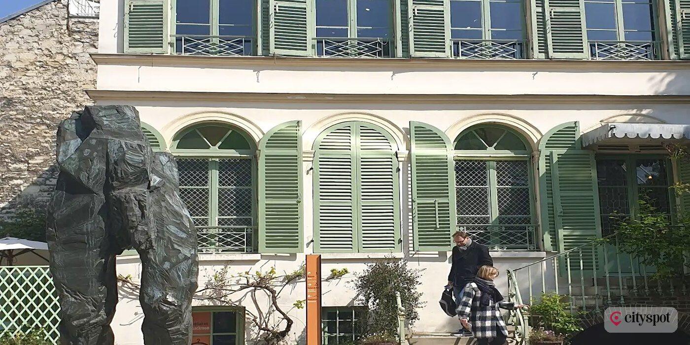 The courtyard of the Musée de la Vie Romantique in Paris, with its bronze sculpture and green-shuttered house