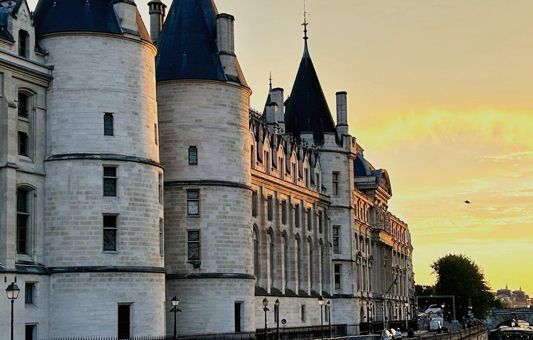 The towers of the Conciergerie on the Seine at sunset